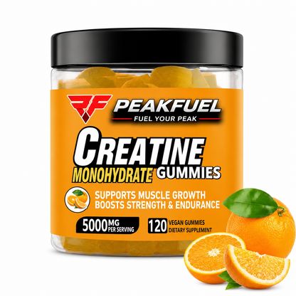 A jar of PeakFuel Creatine Monohydrate Gummies with a black lid and a bright orange label, shown alongside fresh orange slices and a whole orange on a white background.